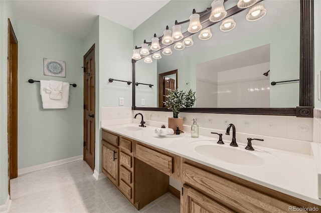 full bathroom featuring tile patterned floors, double vanity, and baseboards