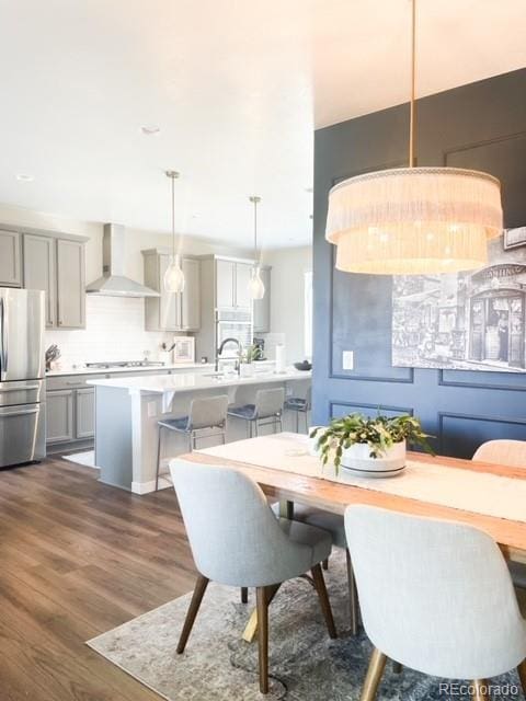 dining area with sink and dark wood-type flooring