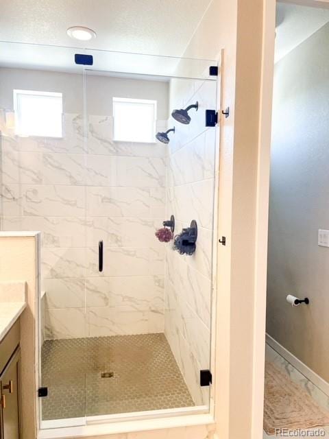 bathroom featuring an enclosed shower and vanity