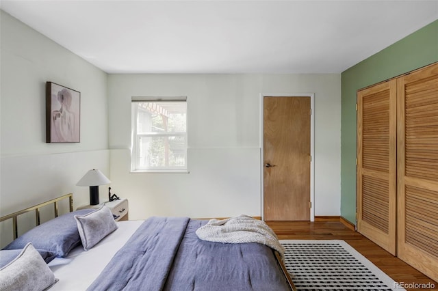 bedroom featuring wood finished floors and a closet
