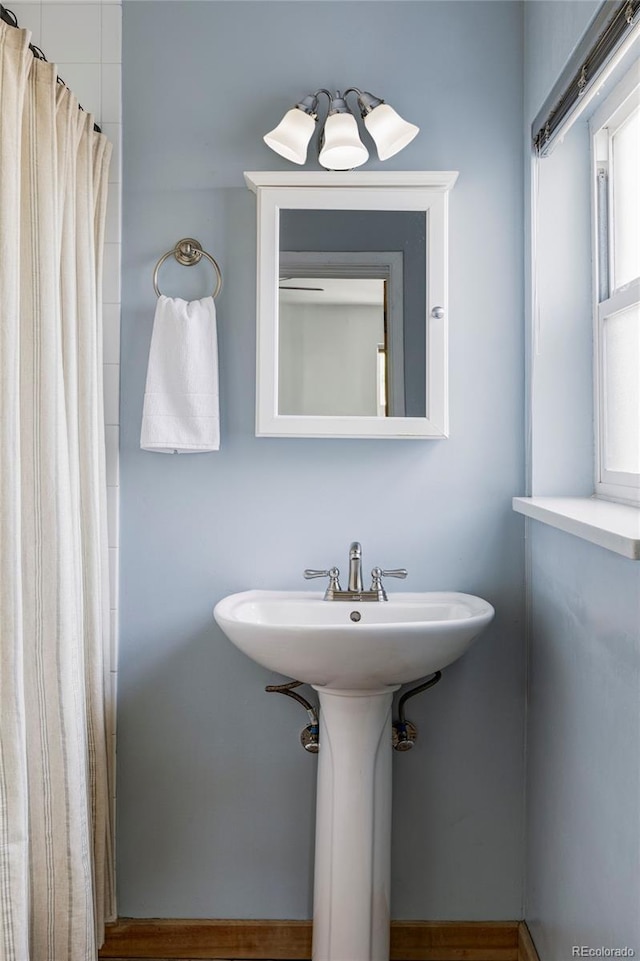 bathroom featuring a sink and curtained shower