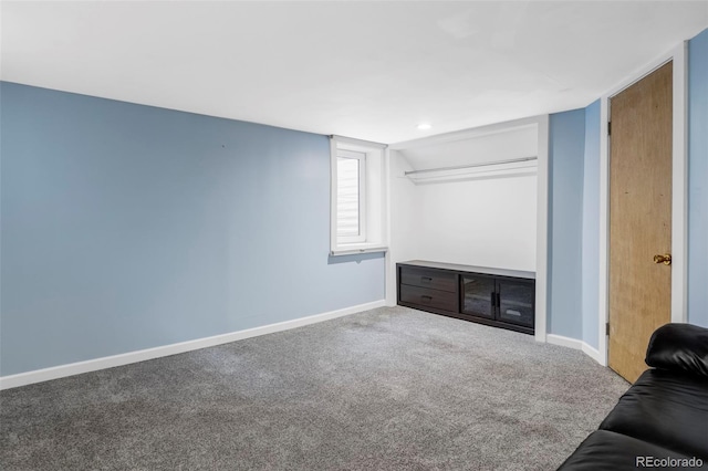 living area featuring carpet floors and baseboards
