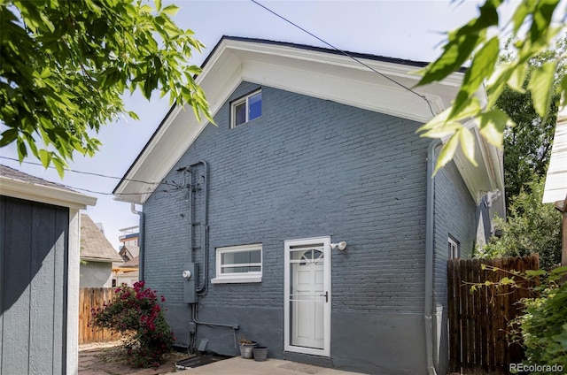 rear view of house with brick siding