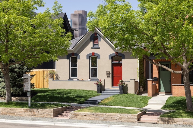 2355 N Emerson St, Denver, CO 80205 - view of front facade featuring fence, stucco siding, and a chimney