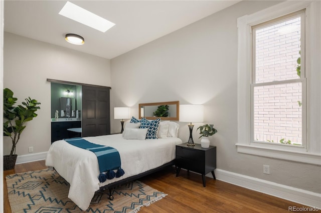 2355 N Emerson St, Denver, CO 80205 - bedroom featuring wood finished floors, baseboards, and a skylight