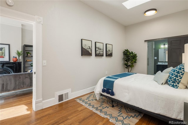 2355 N Emerson St, Denver, CO 80205 - bedroom with wood finished floors, a skylight, and baseboards