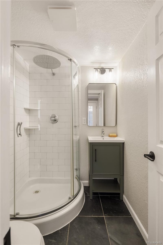 2355 N Emerson St, Denver, CO 80205 - bathroom featuring a shower stall, a textured wall, toilet, a textured ceiling, and vanity