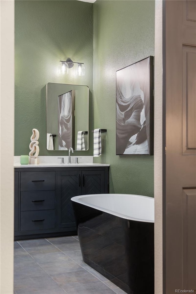 2355 N Emerson St, Denver, CO 80205 - bathroom with a textured wall, tile patterned flooring, and vanity