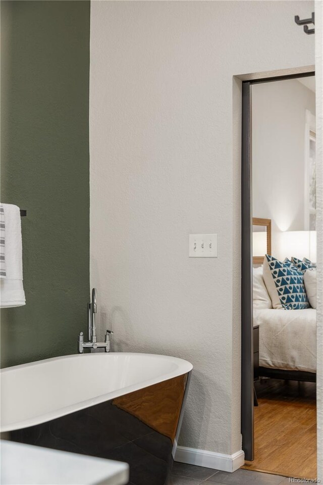 2355 N Emerson St, Denver, CO 80205 - full bathroom with a freestanding tub, ensuite bath, and baseboards
