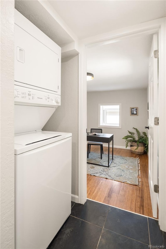 2355 N Emerson St, Denver, CO 80205 - washroom featuring stacked washer / dryer and baseboards