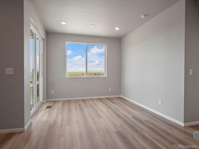 17557 E 89th Way, Commerce City, CO 80022 - empty room featuring light wood finished floors, a smoke detector, and recessed lighting