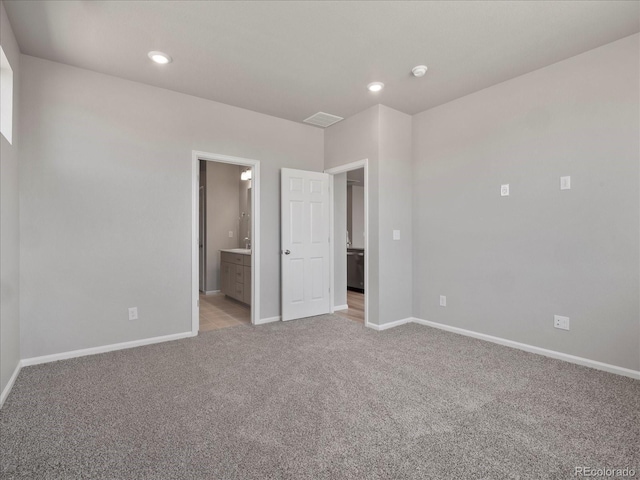 17557 E 89th Way, Commerce City, CO 80022 - unfurnished bedroom featuring light colored carpet, connected bathroom, and recessed lighting