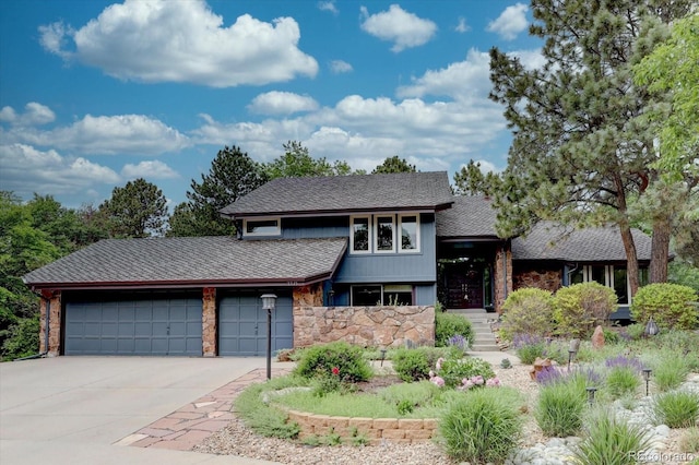 7715 S Hudson Ct, Centennial, CO 80122 - view of front of home featuring stone siding, driveway, a garage, and a shingled roof