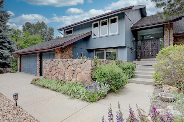 7715 S Hudson Ct, Centennial, CO 80122 - view of front of home with stone siding, driveway, an attached garage, and a shingled roof