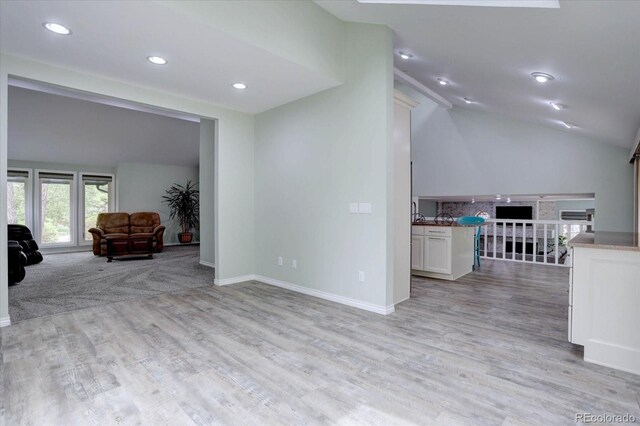 7715 S Hudson Ct, Centennial, CO 80122 - living room with lofted ceiling, recessed lighting, light wood-type flooring, a fireplace, and baseboards