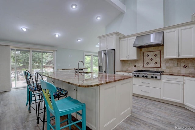 7715 S Hudson Ct, Centennial, CO 80122 - kitchen featuring extractor fan, stainless steel appliances, a sink, light stone counters, and backsplash