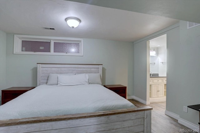 7715 S Hudson Ct, Centennial, CO 80122 - bedroom featuring wood finished floors, ensuite bath, and baseboards
