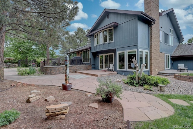 7715 S Hudson Ct, Centennial, CO 80122 - rear view of property with a patio area and a chimney