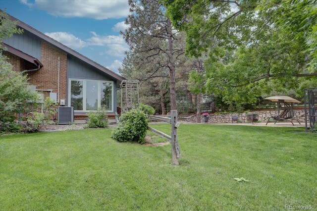 7715 S Hudson Ct, Centennial, CO 80122 - view of green lawn featuring central AC and a patio area