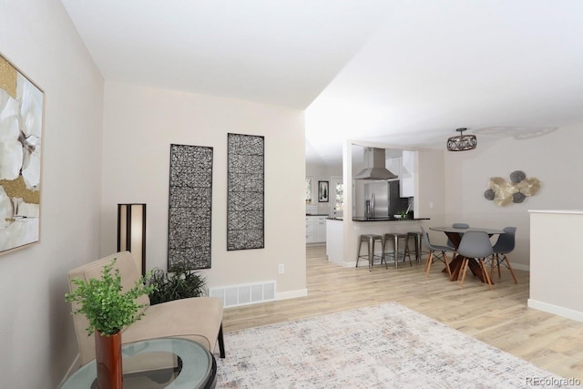 interior space with visible vents, light wood-type flooring, and baseboards