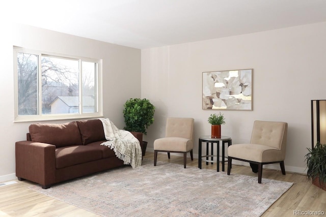 sitting room featuring light wood-type flooring and baseboards