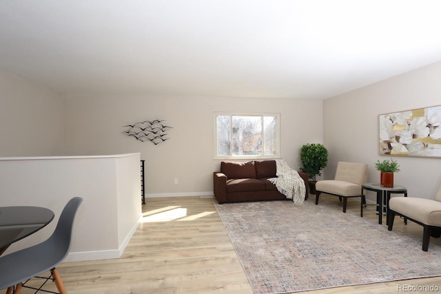 living area with light wood finished floors and baseboards