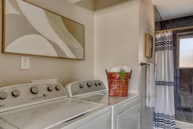 washroom featuring laundry area and washing machine and dryer