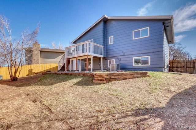 back of property with cooling unit, a deck, stairs, and fence