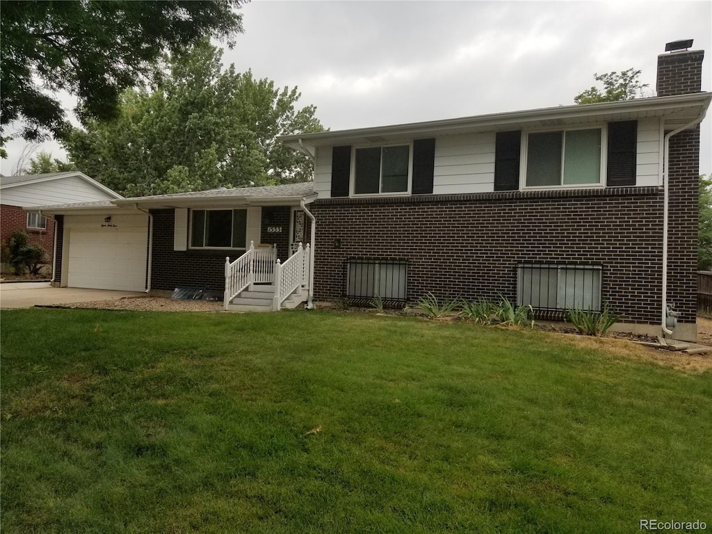 split level home with a garage and a front yard