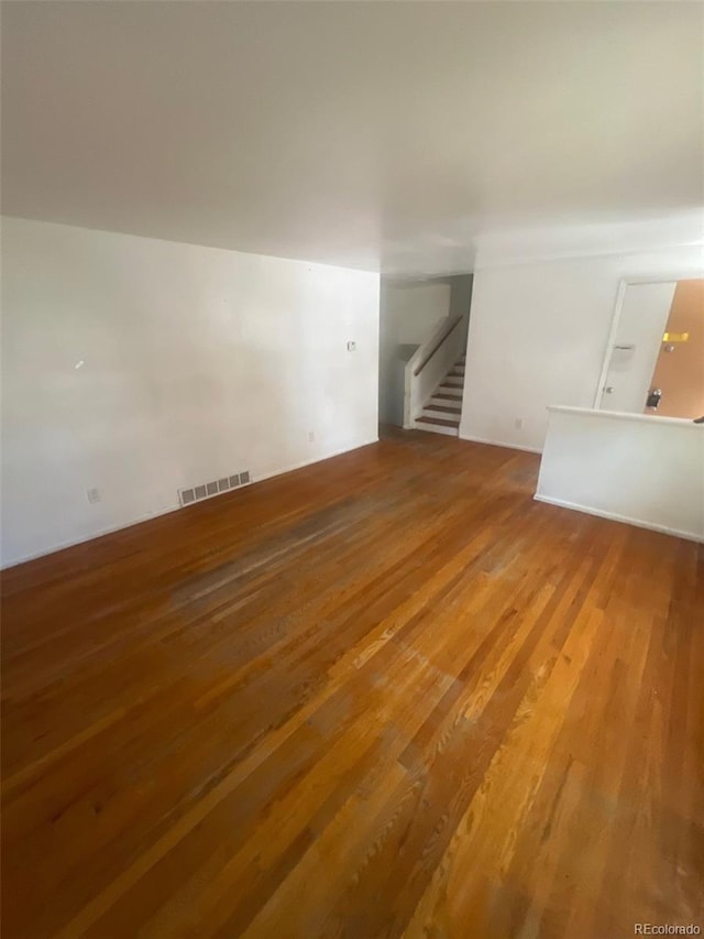 1533 S Jamaica St, Aurora, CO 80012 - unfurnished living room with wood finished floors and stairs