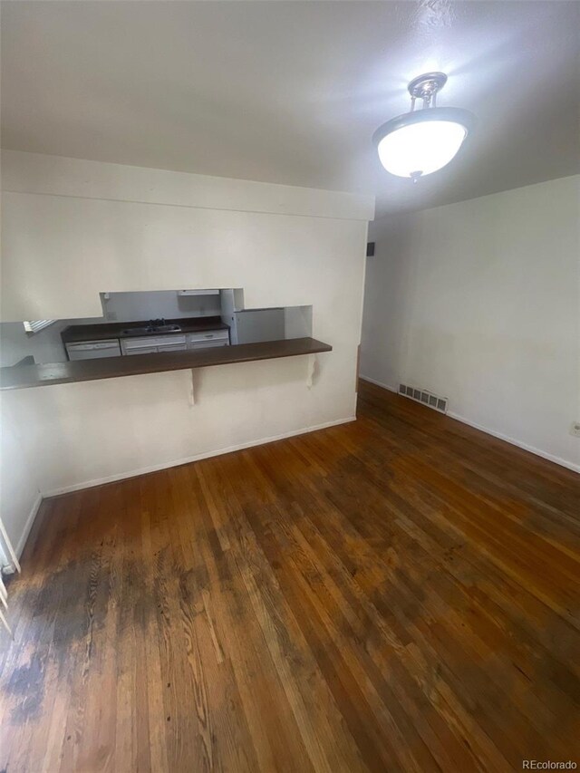 1533 S Jamaica St, Aurora, CO 80012 - unfurnished living room featuring hardwood / wood-style floors and baseboards