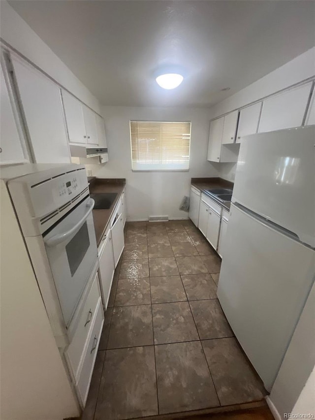 1533 S Jamaica St, Aurora, CO 80012 - kitchen featuring white appliances, dark countertops, white cabinets, and under cabinet range hood