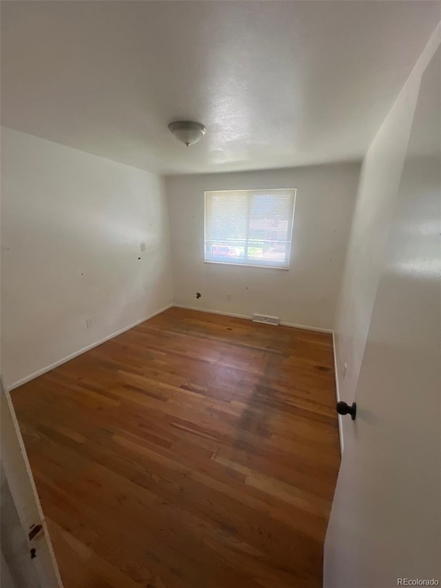 1533 S Jamaica St, Aurora, CO 80012 - empty room with wood finished floors and baseboards