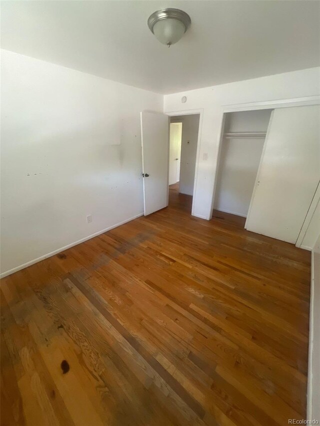 1533 S Jamaica St, Aurora, CO 80012 - unfurnished bedroom featuring wood finished floors and a closet
