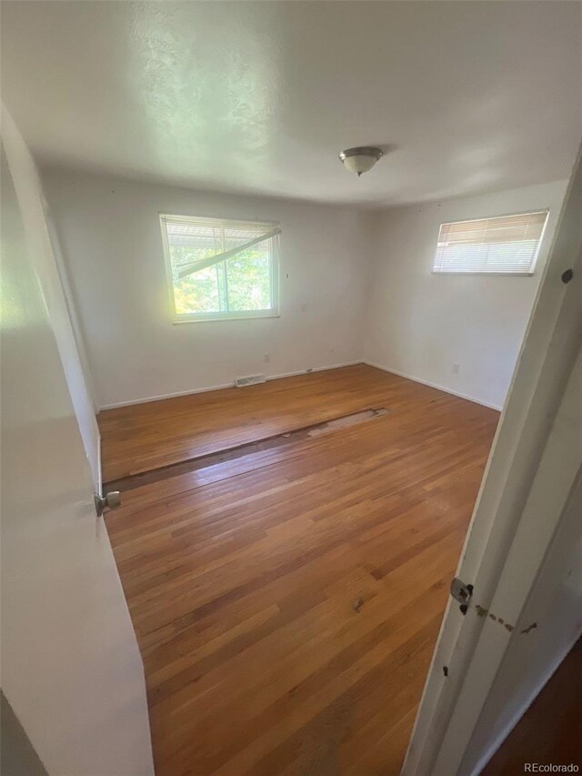 1533 S Jamaica St, Aurora, CO 80012 - empty room featuring wood finished floors