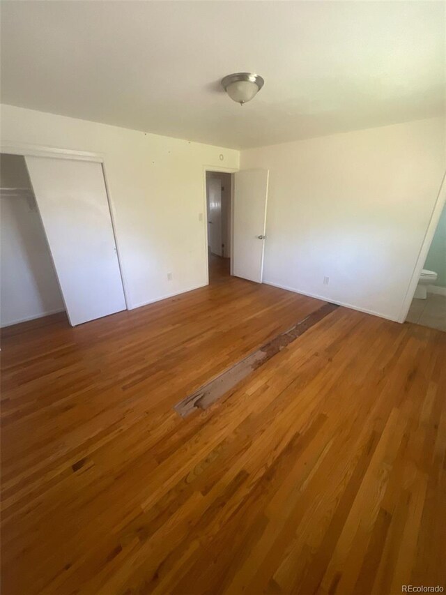 1533 S Jamaica St, Aurora, CO 80012 - unfurnished bedroom featuring light wood-style floors and a closet