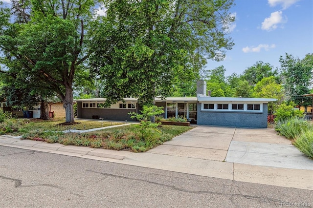 6057 S Windermere Way, Littleton, CO 80120 - view of front of property featuring driveway, a chimney, and a front yard