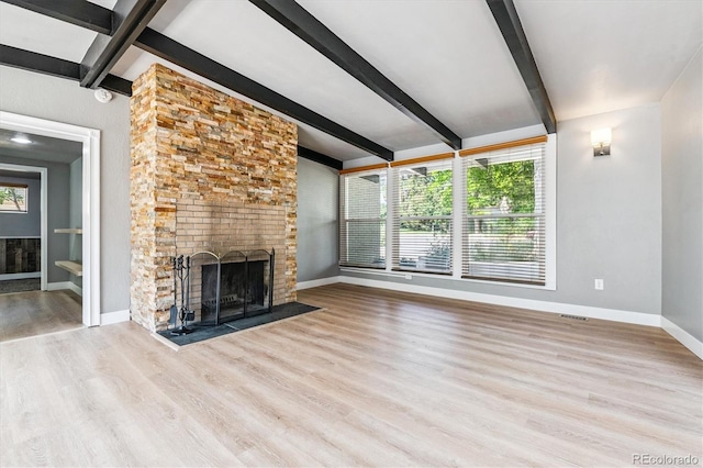 6057 S Windermere Way, Littleton, CO 80120 - unfurnished living room with a fireplace, beam ceiling, and wood finished floors