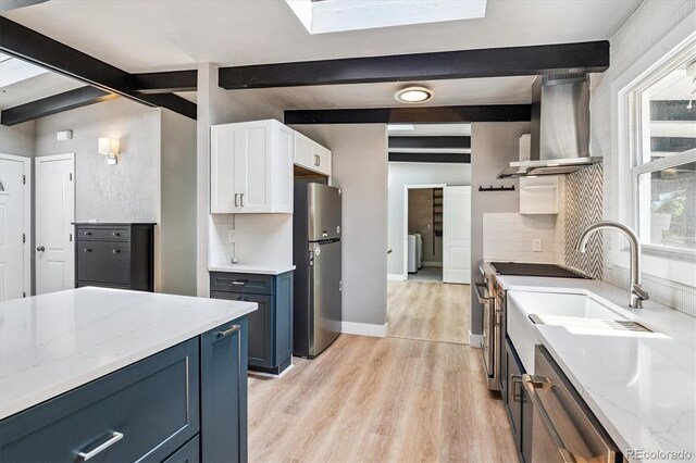 6057 S Windermere Way, Littleton, CO 80120 - kitchen featuring stainless steel appliances, beam ceiling, wall chimney range hood, light wood-style flooring, and decorative backsplash
