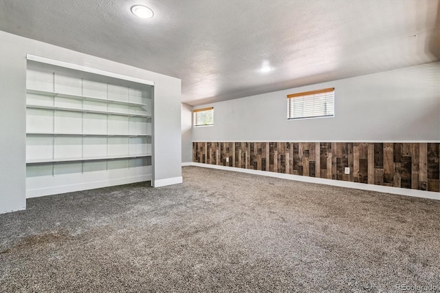6057 S Windermere Way, Littleton, CO 80120 - carpeted spare room featuring a textured ceiling and wooden walls