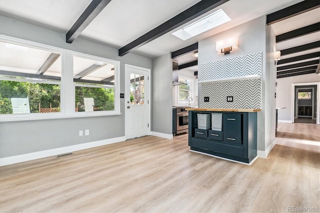 6057 S Windermere Way, Littleton, CO 80120 - bar area with beamed ceiling, a skylight, light wood-type flooring, and wall chimney exhaust hood