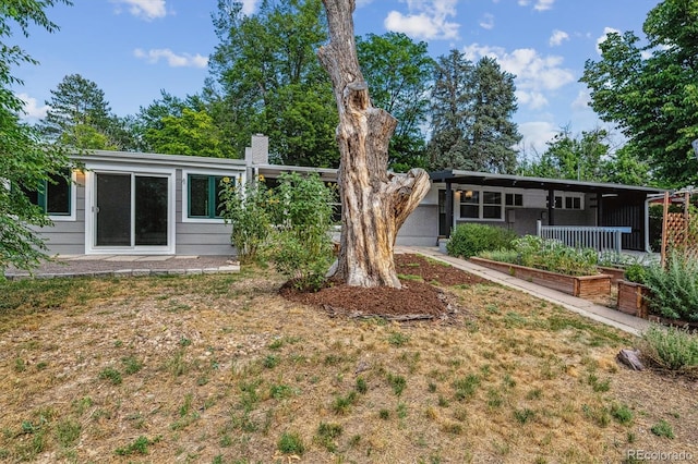 6057 S Windermere Way, Littleton, CO 80120 - rear view of property with a chimney and a lawn