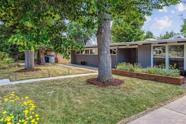 6057 S Windermere Way, Littleton, CO 80120 - view of front facade featuring brick siding and a front yard