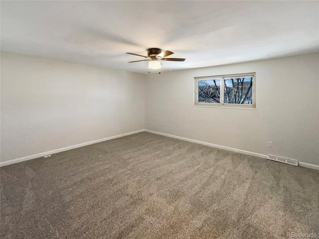 spare room with ceiling fan and carpet