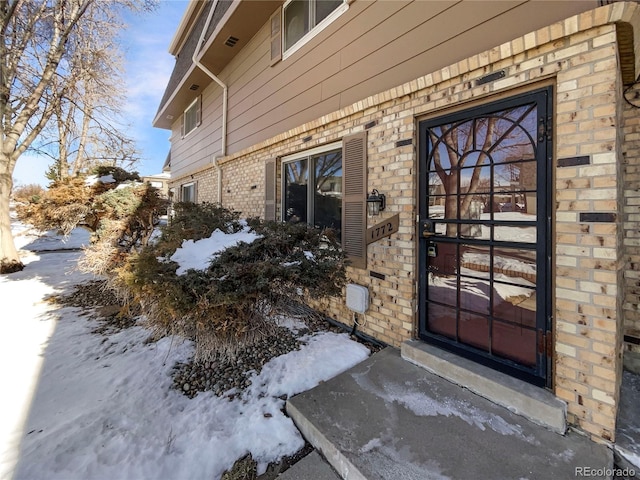 view of snow covered property entrance