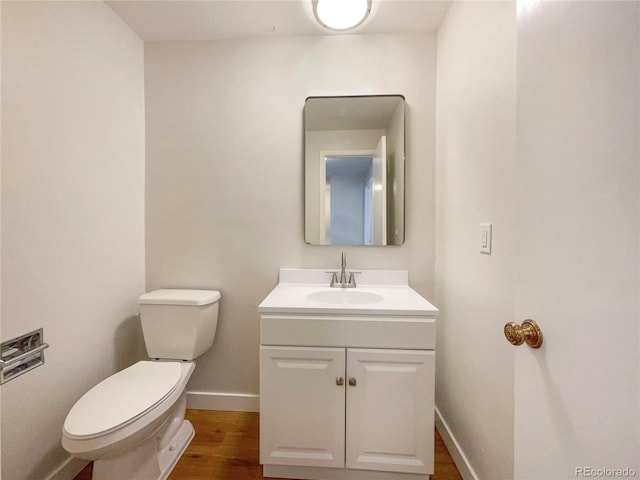 bathroom with vanity, hardwood / wood-style floors, and toilet