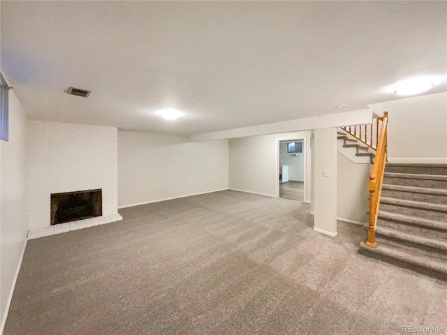 basement with carpet floors and a brick fireplace