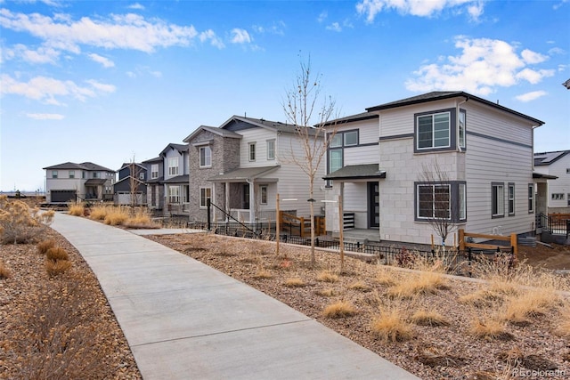 view of front of home featuring a residential view and fence