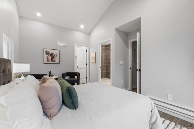 bedroom featuring baseboard heating, ensuite bathroom, hardwood / wood-style floors, and high vaulted ceiling