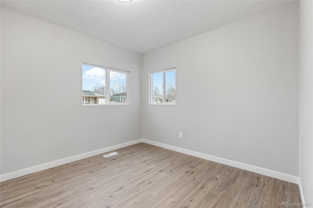 spare room with light hardwood / wood-style flooring